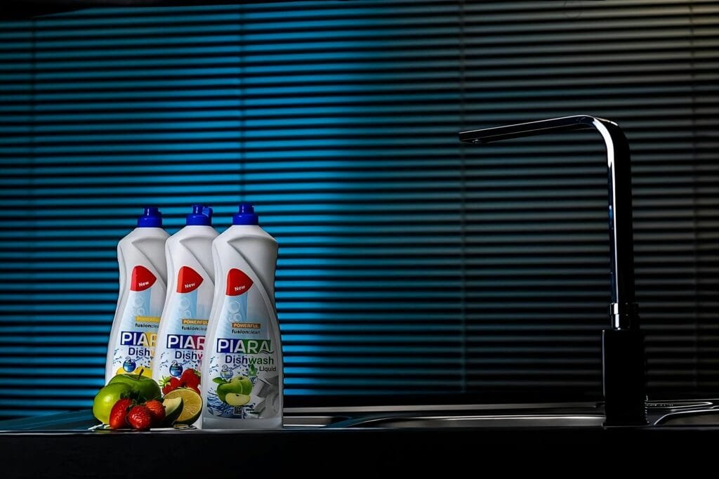 Piara Dishwash Liquid bottles with fresh fruit in modern kitchen setting, Qazvin, Iran.