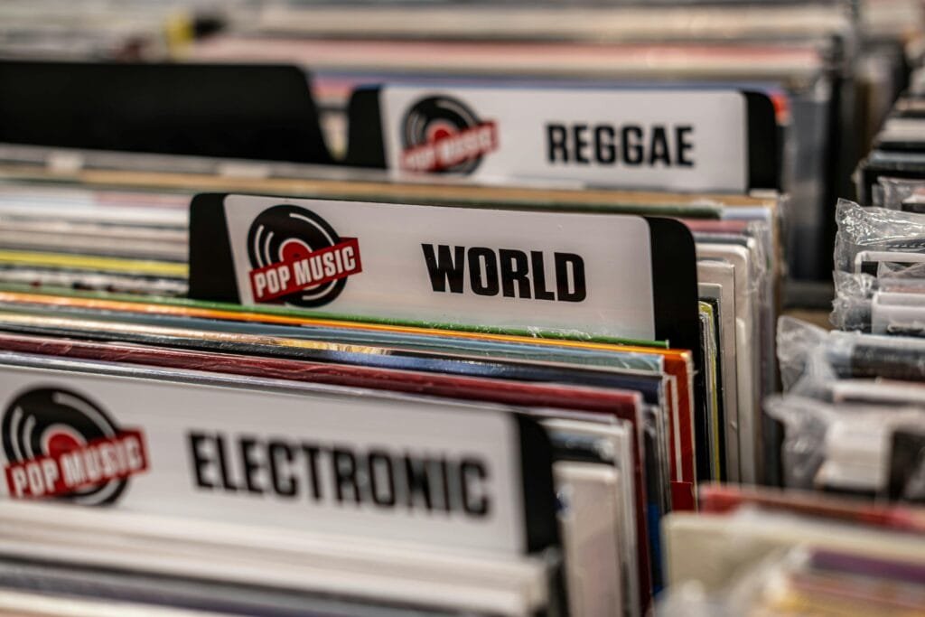 Close-up of vinyl records categorized by music genres at a Toronto store.