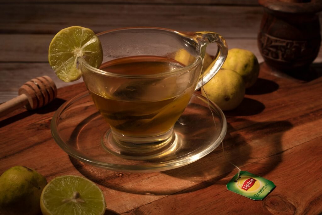 Close-up of lemon tea with honey on a wooden surface, evoking warmth and comfort.